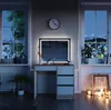 A vanity table with an LED mirror is set up in a room at night, with windows showing a snowy mountain landscape. Náhled obrázku produktu