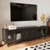 A black TV stand with glass doors and gold handles is shown against a light gray wall, with a large black TV mounted above it. Anteprima dell’immagine prodotto