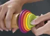 Hands are holding a wooden rolling pin with colorful rings attached. Produktbild-Vorschau