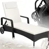 A rattan sun lounger with a white cushion is shown against a white and light gray background. There are also some water droplet-like shapes on the surface. Náhled obrázku produktu
