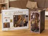 A Harry Potter Diagon Alley book nook kit is shown on a wooden table, with the box on the left and the assembled kit on the right. Produktbild-Vorschau