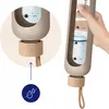 A hand holding a water bottle with measurement markings, and a close-up of the bottle's base with a water droplet icon. Produktbild-Vorschau
