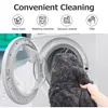 A person is putting a gray beanbag cover into a washing machine. Produktbild-Vorschau