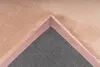 Close-up view of the corner of a rug, showing the texture of the pile and the backing material. Produktbild-Vorschau