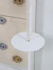 A close-up view of a wooden climbing wall with a rope swing attached. Voir les images du produit