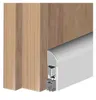 A close-up view of a door bottom seal attached to a wooden door frame. Produktbild-Vorschau