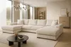 A spacious living room with a large sectional sofa, coffee table, and bookshelf. Produktbild-Vorschau