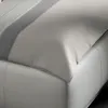 A close-up view of a bed with a duvet cover. Produktbild-Vorschau