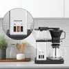 A coffee maker is shown on a kitchen counter with a tiled backsplash. Produktbild-Vorschau