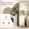 A bathroom cabinet is shown next to a washing machine, with decorative items and toiletries. Voir les images du produit