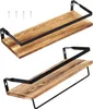 Two wooden shelves with black metal brackets are displayed against a white background. The top shelf has a simple bracket, while the bottom shelf has a bracket that extends downwards to form a towel bar. Náhled obrázku produktu