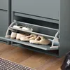 A close-up view of a gray shoe cabinet with three flip-out shelves, displaying various types of footwear. Náhled obrázku produktu