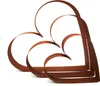 Three abstract heart shapes made of rusted metal, arranged in a layered composition against a white background. Produktbild-Vorschau