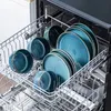 A close-up view of a dishwasher rack filled with blue ceramic plates and bowls. Náhled obrázku produktu