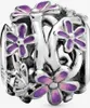 A close-up of a silver charm with purple enamel flowers. Produktbild-Vorschau