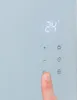 A finger is pressing a button on a white electronic device with a digital display. Produktbild-Vorschau