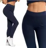 A woman wearing navy blue ribbed leggings and a matching top, shown from the side and a close-up of the waist and hips.