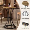 A round bar table with two glasses of wine and two bottles of alcohol on top, set in a home bar environment with brick walls and wooden cabinets. Produktbild-Vorschau