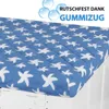 A close-up of a blue washing machine cover with white star patterns, placed on top of a white washing machine. Anteprima dell’immagine prodotto