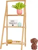 A dollhouse shelf with accessories including a plant, a light-up sign, a small container, and a toy hammer. A small dog figurine is also present. Náhľad obrázku produktu