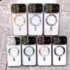 A collection of smartphone cases arranged in a grid on a newspaper background. Produktbild-Vorschau
