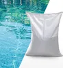 A white bag of filter media is placed next to a swimming pool. Anteprima dell’immagine prodotto