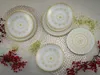 A set of decorative plates arranged on placemats with festive embellishments. Náhľad obrázku produktu