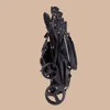 A folded black baby stroller is shown against a plain light brown background. Produktbild-Vorschau