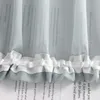 A close-up of a sheer curtain with text printed on it, featuring ruffled edges. Produktbild-Vorschau