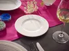 A table setting with a white plate, a glass of white wine, and small containers of blue and green substances. Podgląd zdjęcia produktu
