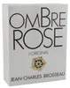 Weiße Parfumverpackung mit großem schwarzen Schriftzug „Ombre Rose“, goldener Blüte und Namenszug Jean-Charles Brosseau. Anteprima dell’immagine prodotto