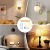 A collage of four different scenes showing various types of wall sconces and a table lamp, with a central inset highlighting a rechargeable LED bulb and remote control. Produktbild-Vorschau