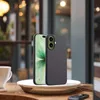 A smartphone case is displayed on a plate next to a white mug on a wooden table. Produktbild-Vorschau