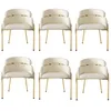 Six beige upholstered dining chairs with gold metal legs are arranged in two rows of three against a white background. Produktbild-Vorschau