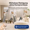 Three women are using cordless vacuum cleaners in a modern living room. A dog is lying on the carpet in the foreground. Produktbild-Vorschau