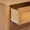 A close-up view of a wooden drawer cabinet with cane detailing. Podgląd zdjęcia produktu