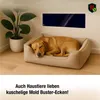 A dog sleeping in a dog bed next to a plant, with a wall-mounted heater in the background. Náhled obrázku produktu