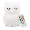 A white owl-shaped night light with a remote control. Produktbild-Vorschau