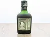 A bottle of Diplomático Reserva Exclusiva rum is displayed on a wooden surface against a white background. Voir les images du produit