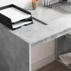 A close-up view of a desk with a paper tray, a laptop, and a pencil holder. Náhled obrázku produktu