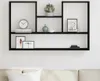 A black wall shelf with various decorative items on it, mounted on a white wall above a sofa. Náhľad obrázku produktu