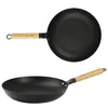 Two views of a black cast iron frying pan with a wooden handle, presented on a white background. Podgląd zdjęcia produktu