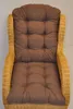 A close-up view of a brown cushion on a wicker chair. Produktbild-Vorschau