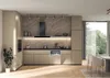 A modern, integrated kitchen with beige cabinets, a black range hood, and a marble-patterned backsplash. Voir les images du produit