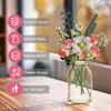 A bouquet of artificial flowers in a glass vase, with feature callouts on the left. Produktbild-Vorschau