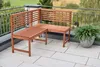 A wooden corner bench on a balcony with a plant. Produktbild-Vorschau