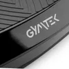 A close-up view of the Gymtek logo on a black surface, with a textured pattern visible above. Voir les images du produit
