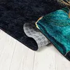 A close-up view of a rug, showing the texture and a rolled-up edge. Náhled obrázku produktu