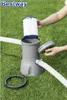 A person is shown assembling a Bestway filter pump on a grassy lawn. Produktbild-Vorschau