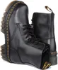 A pair of black Dr. Martens boots. Anteprima dell’immagine prodotto